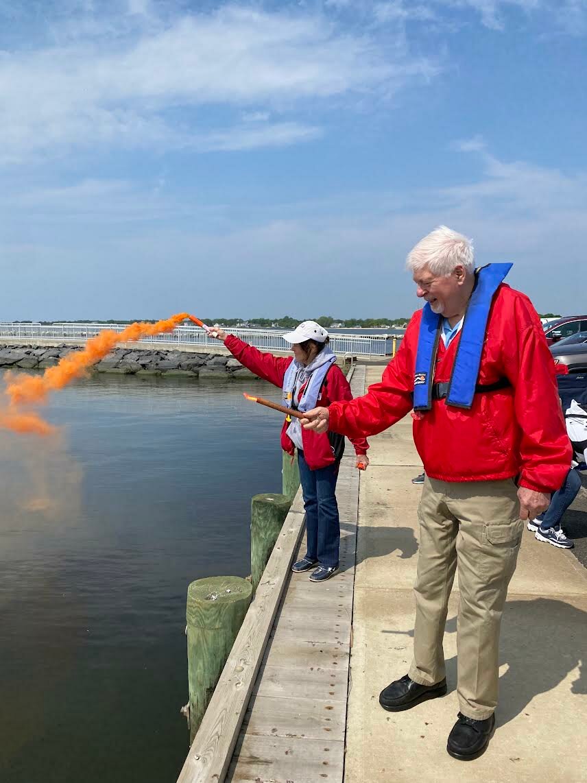 Squadron Cmdr. Loretta Yeamans and squadron member Dick Jost, senior navigator, past commander and the chairperson of the NYS Boating Certification Course Program, of Wading River, demonstrate flare technique.